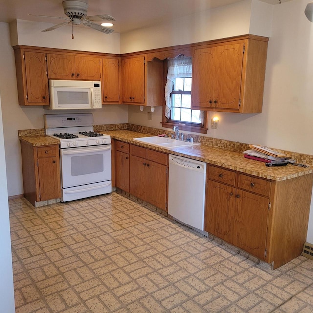 kitchen featuring ceiling fan, sink, and white appliances