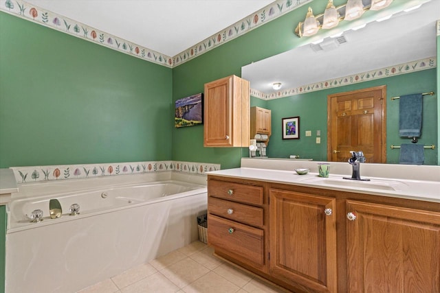 bathroom with tile patterned flooring, vanity, and a bath