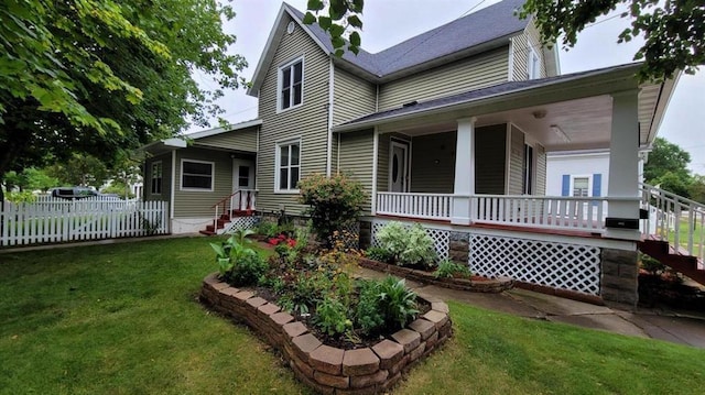 back of house with a porch and a lawn