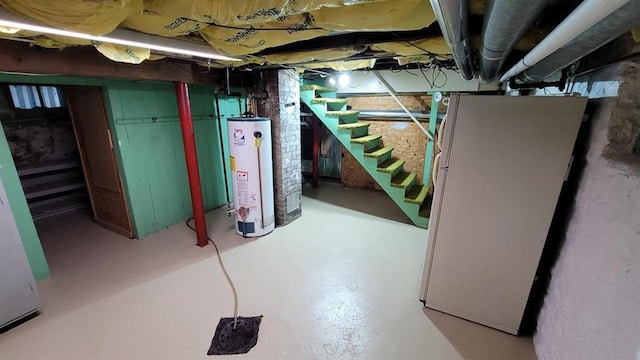 basement with water heater and white fridge