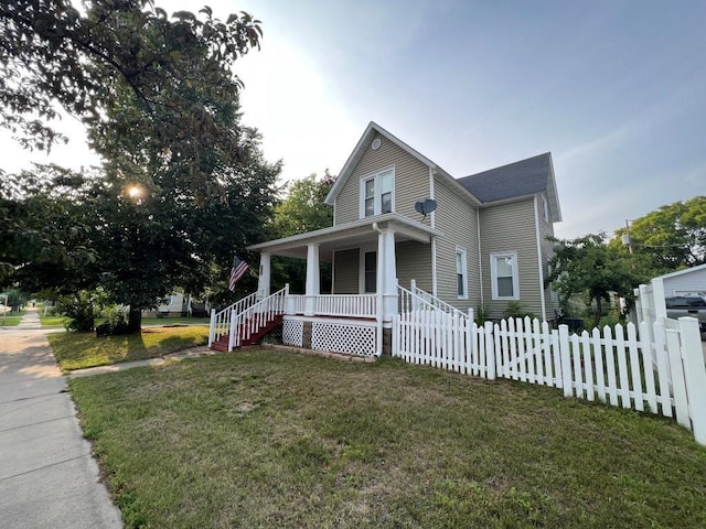 farmhouse-style home featuring a porch and a front yard