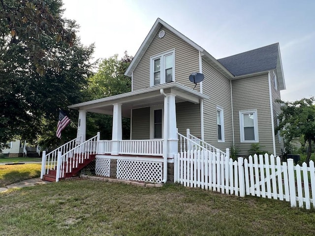 farmhouse with a porch and a front yard