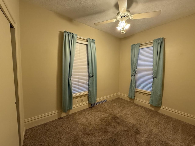 carpeted empty room featuring a textured ceiling and ceiling fan