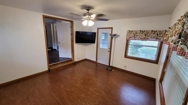 spare room featuring ceiling fan and dark hardwood / wood-style flooring