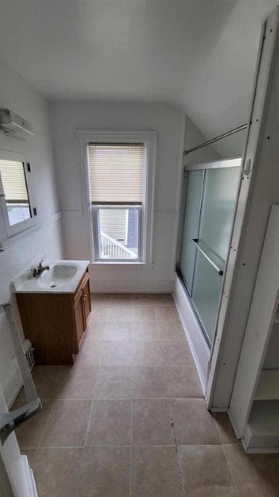 bathroom featuring an enclosed shower and vanity