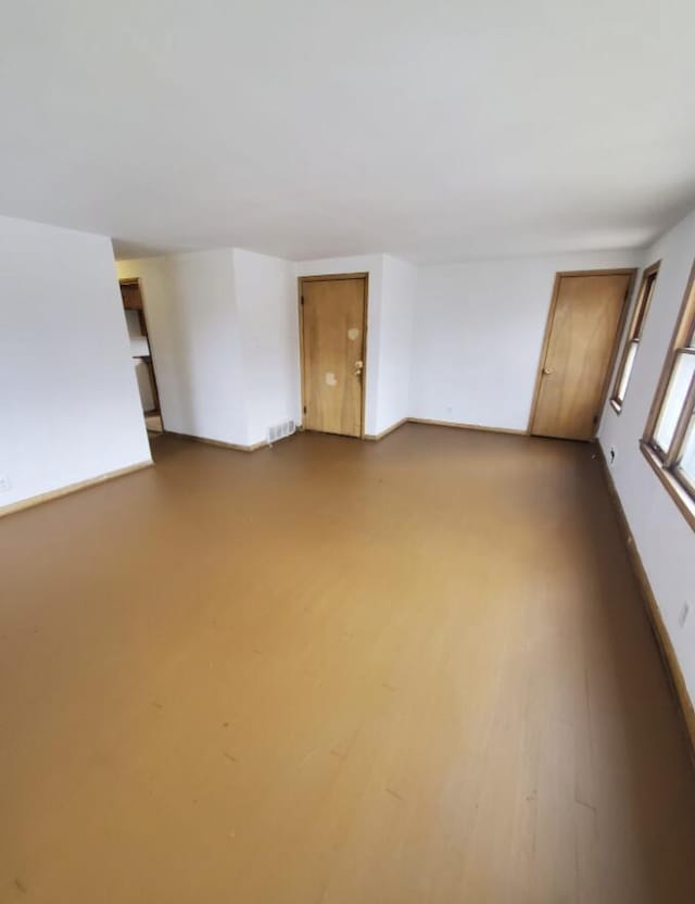 empty room with dark hardwood / wood-style flooring