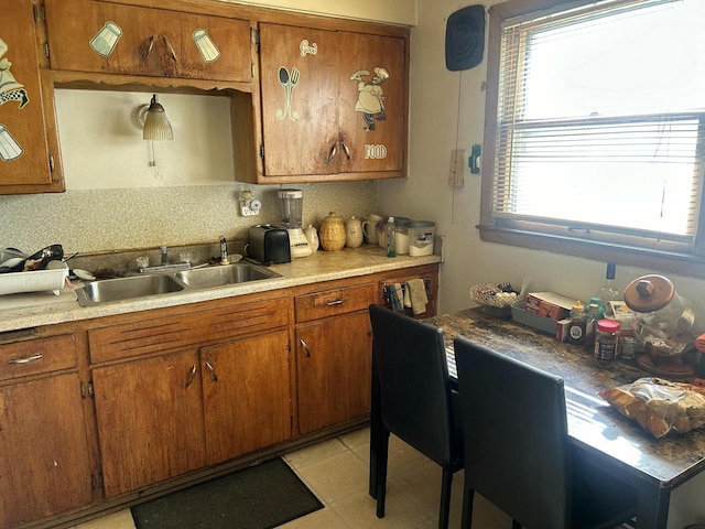 kitchen featuring light tile patterned floors, sink, and tasteful backsplash