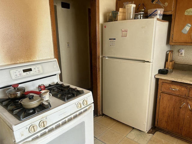 kitchen with tasteful backsplash and white appliances