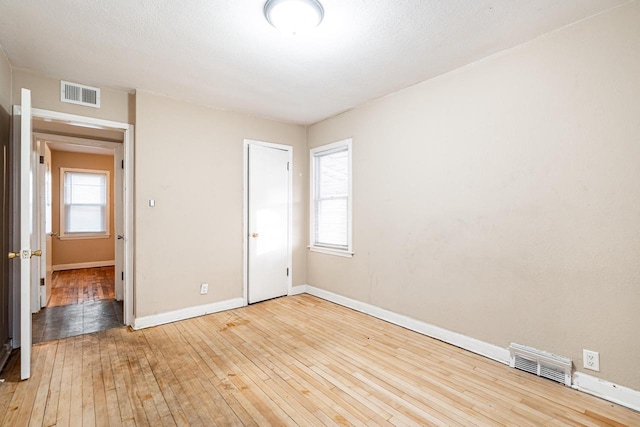 unfurnished bedroom featuring a closet and wood-type flooring