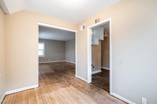 empty room with hardwood / wood-style flooring