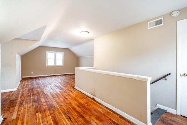 bonus room featuring hardwood / wood-style floors and vaulted ceiling