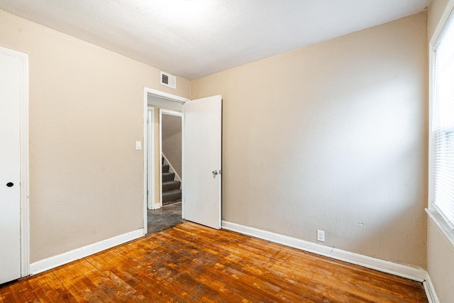 spare room with hardwood / wood-style floors