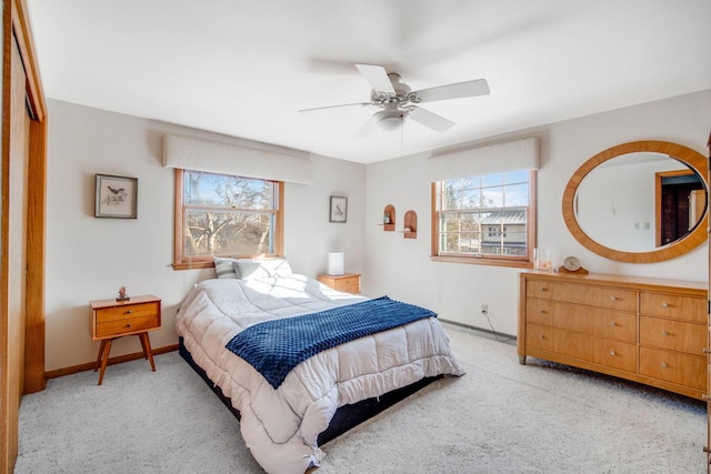 bedroom with light carpet, a closet, and ceiling fan