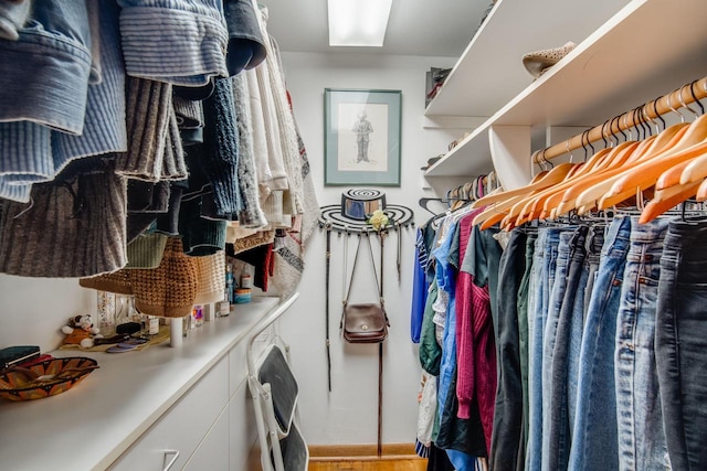 walk in closet with light wood-type flooring