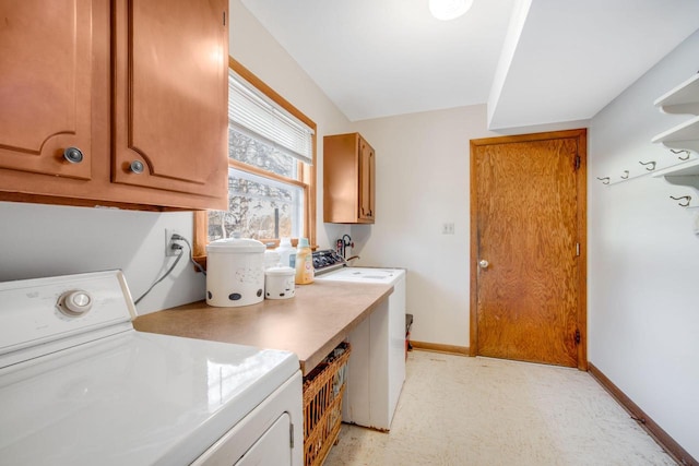 laundry room with washer and clothes dryer and cabinets