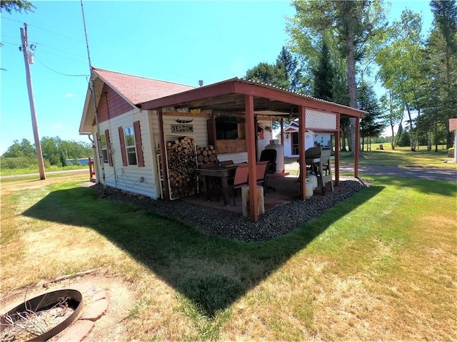 back of house with a lawn