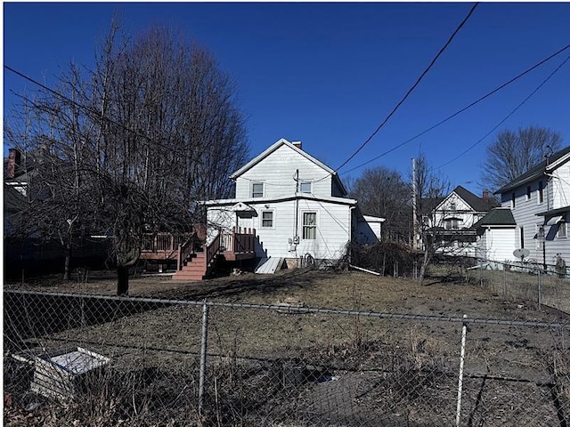 back of house with a deck