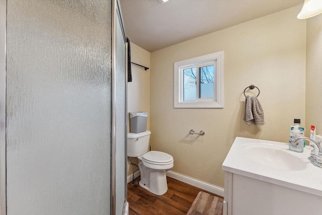 bathroom featuring a shower with shower door, wood-type flooring, toilet, and vanity