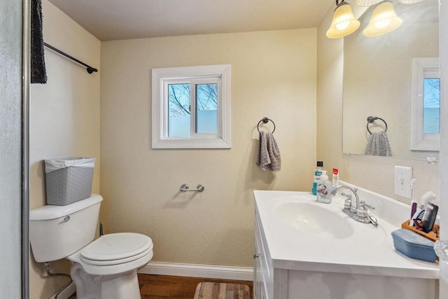 bathroom featuring toilet, vanity, and hardwood / wood-style flooring