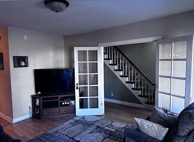 unfurnished living room featuring hardwood / wood-style flooring and french doors