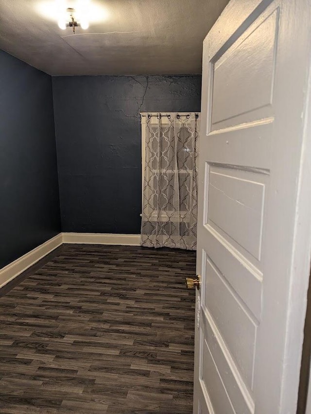 unfurnished room featuring dark hardwood / wood-style floors