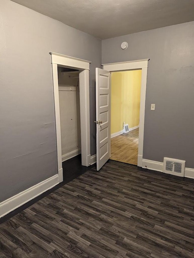 unfurnished bedroom featuring dark wood-type flooring