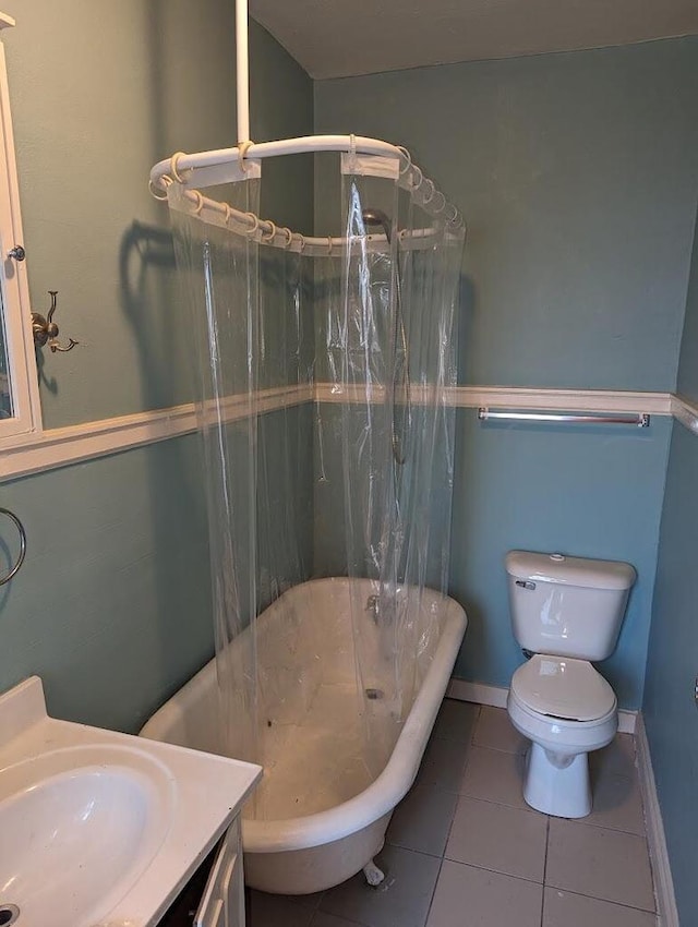 full bathroom featuring toilet, shower / bath combination with curtain, vanity, and tile patterned floors