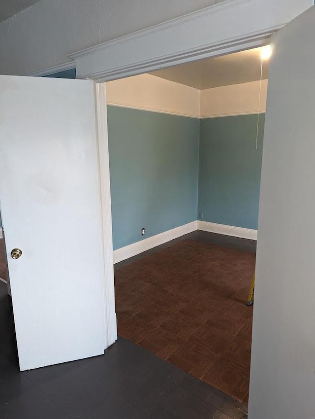 spare room featuring dark parquet floors