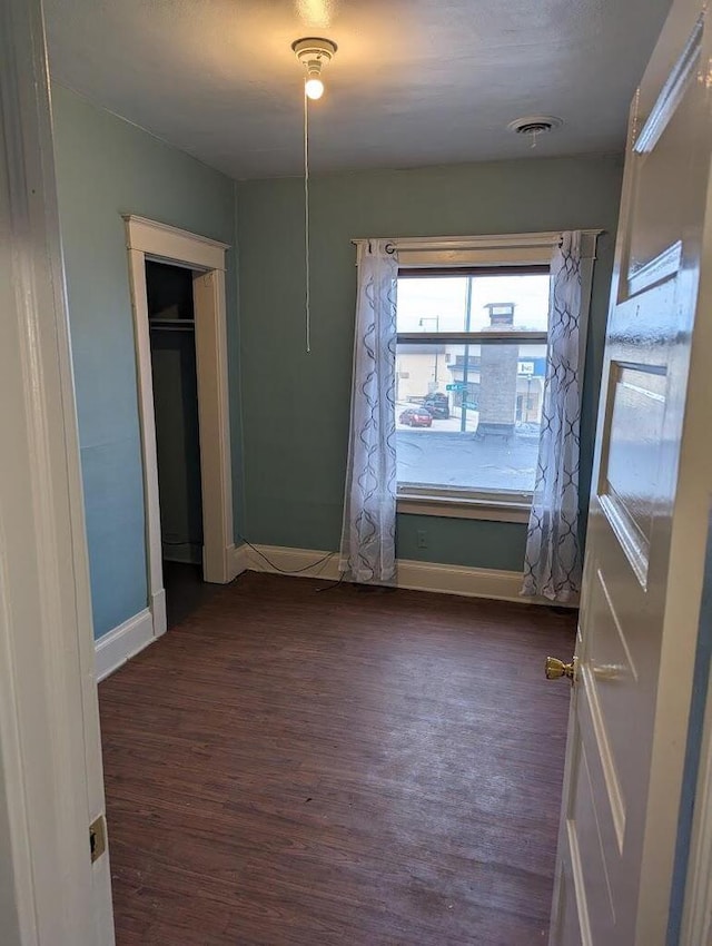 unfurnished bedroom featuring dark hardwood / wood-style flooring