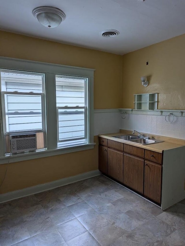 kitchen with decorative backsplash, cooling unit, and sink