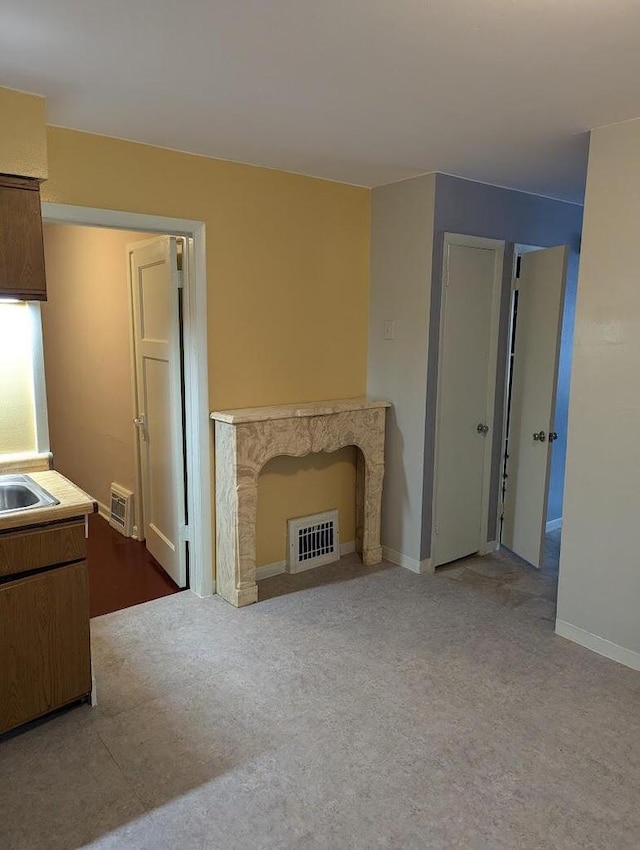 unfurnished living room with sink