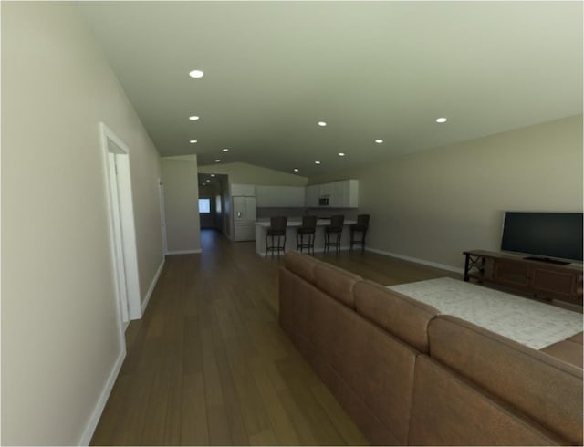 living room with hardwood / wood-style floors and vaulted ceiling