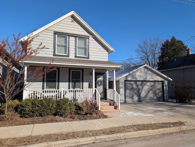 view of front of property featuring covered porch, a garage, and an outbuilding