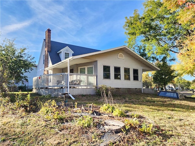 back of property featuring a lawn