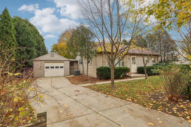 ranch-style home with cooling unit, an outdoor structure, and a garage