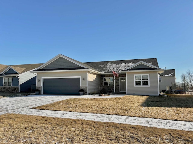 ranch-style home featuring a garage and a front yard