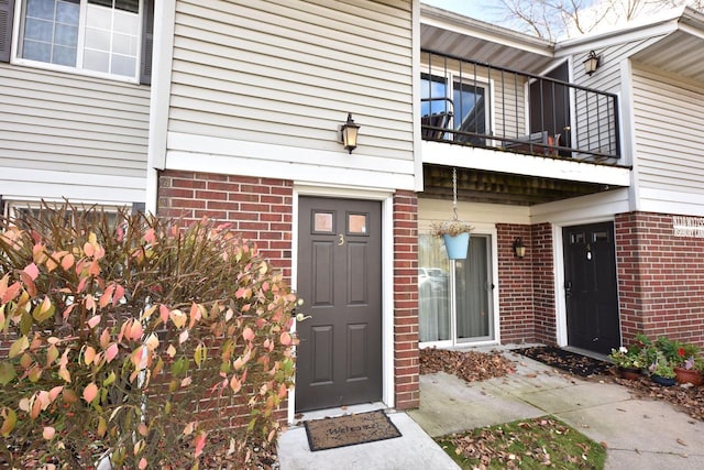 view of exterior entry featuring a balcony