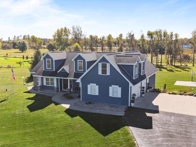 cape cod house featuring a garage and a front lawn