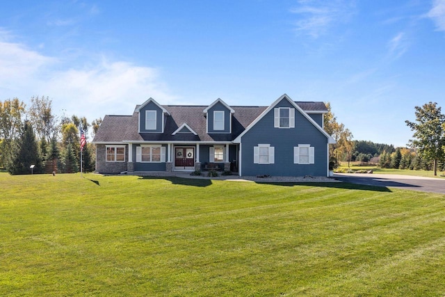 cape cod-style house featuring a front lawn and covered porch