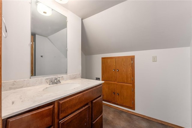 bathroom with lofted ceiling and vanity