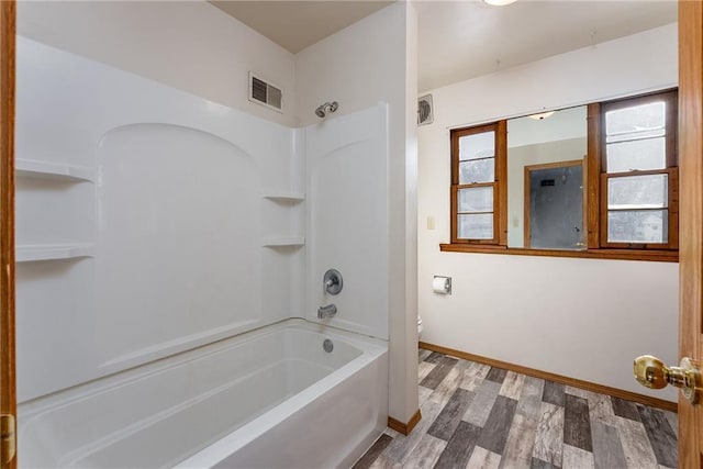 bathroom featuring shower / tub combination, toilet, and wood-type flooring