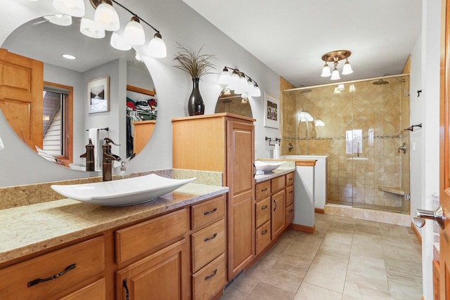 bathroom featuring a shower with door, tile patterned flooring, and vanity