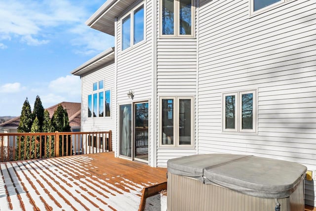 wooden deck featuring a hot tub