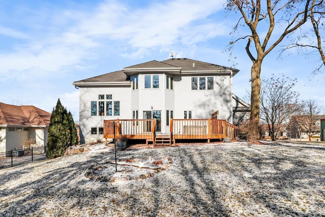 rear view of property with a wooden deck