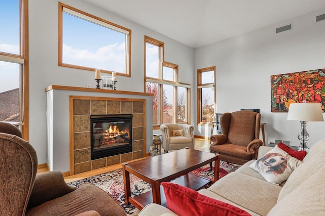 living room featuring a tiled fireplace