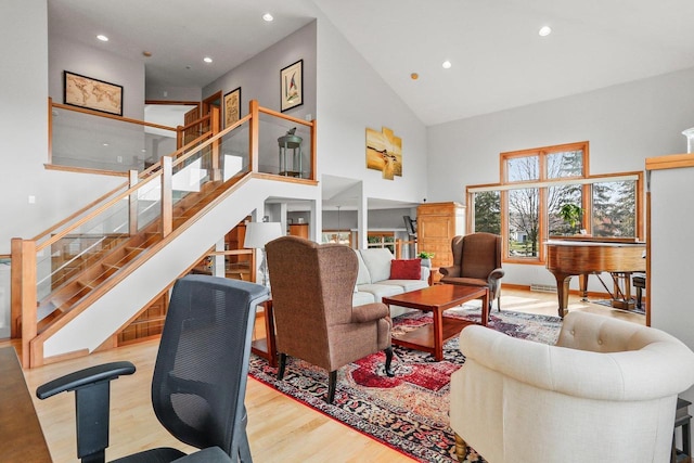 living room featuring high vaulted ceiling and light wood-type flooring