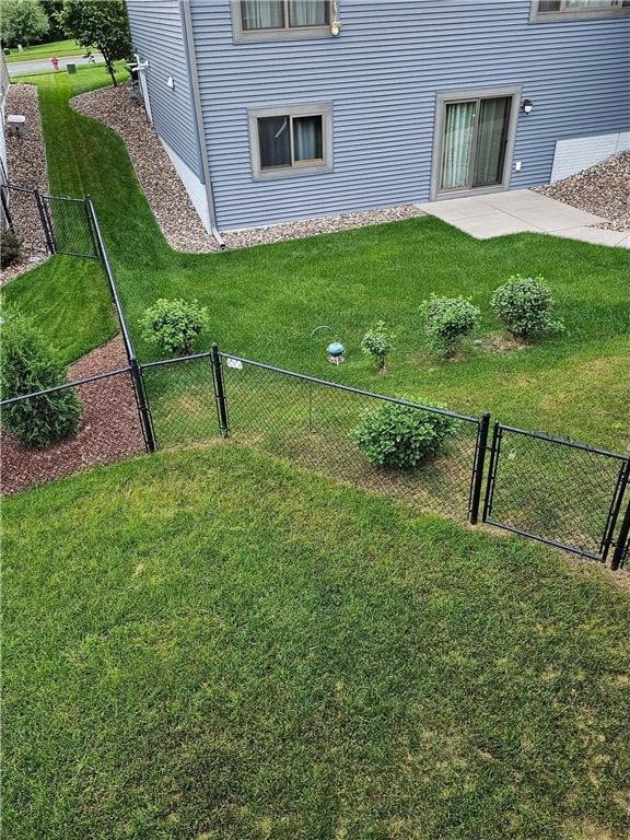 view of yard with a gate, fence, and a patio