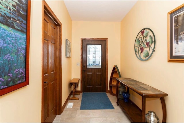 doorway with light tile patterned floors