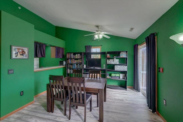 dining area with ceiling fan, light hardwood / wood-style flooring, and lofted ceiling