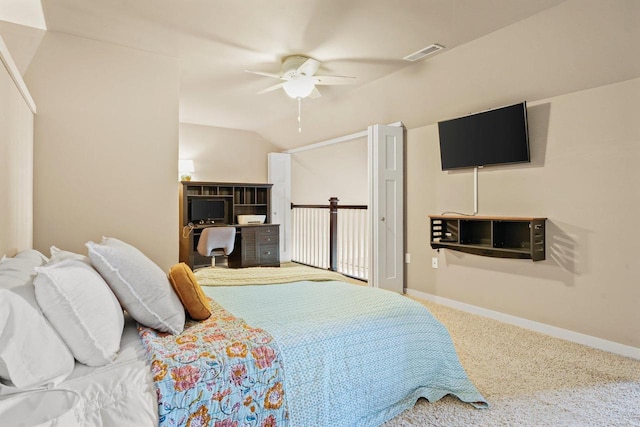 bedroom with ceiling fan, vaulted ceiling, and carpet flooring